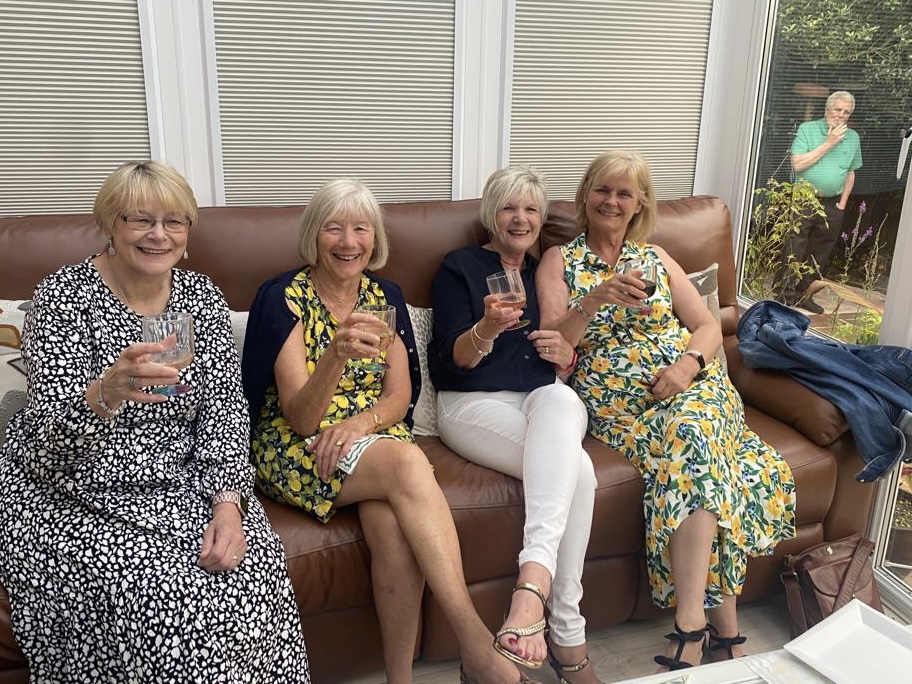 Janet, Kay, Joan and Sharon posing for the camera. Who\'s that lurking in the garden?