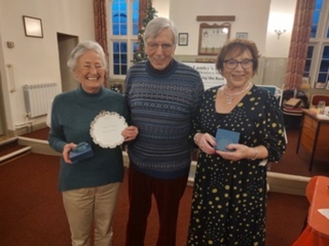 Anne and Joan winners of the highest percentage in 2025 with their trophies presented by Peter Jaram, Club Chaiman